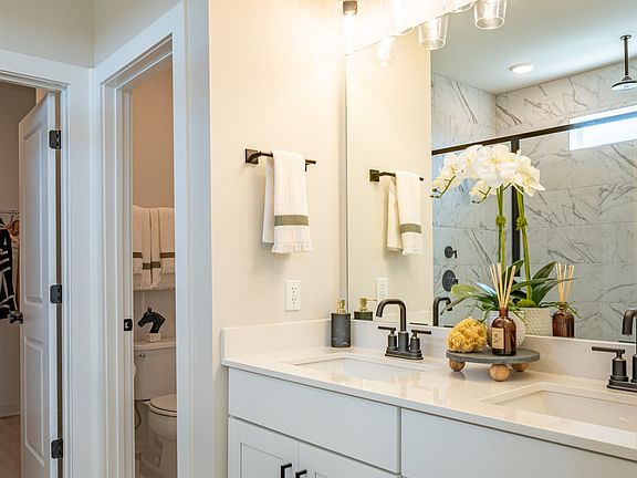 Bathroom with separate water closet, dual vanity, and large walk-in closet