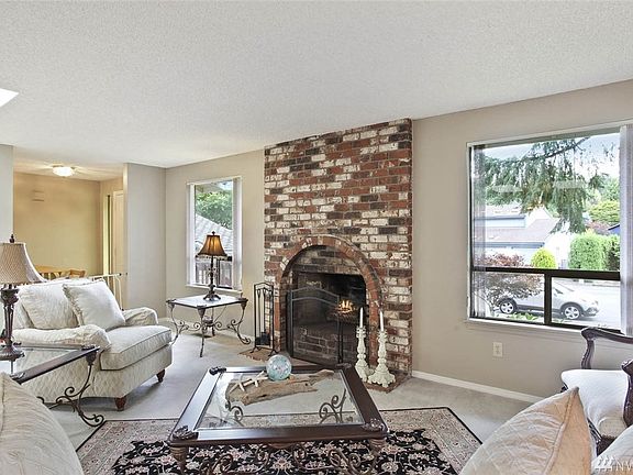 A cozy wood burning fireplace adds character and warmth to this welcoming living room.