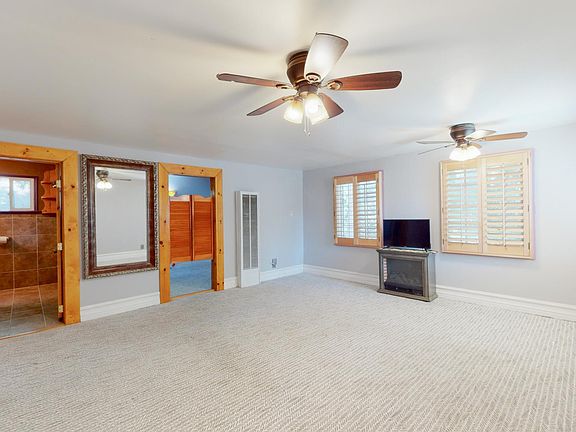 UNFURNISHED MASTER BEDROOM LEADING TO SIDE OFFICE AND MASTER BATHROOM. COMPLIMENTARY BRAND NEW TV WITH AMAZON PRIME, HULU, NETFLIX, EPIX, SHOWTIME, DISNEY, ESPN ALREADY PROGRAMMED AND FAUX FIREPLACE
