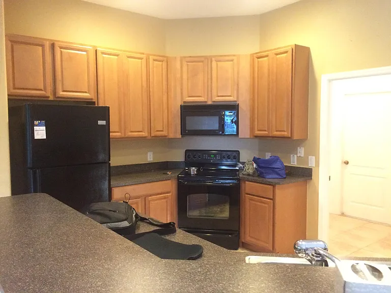 Large modern kitchen next to laundry room and entrance to 3 car garage