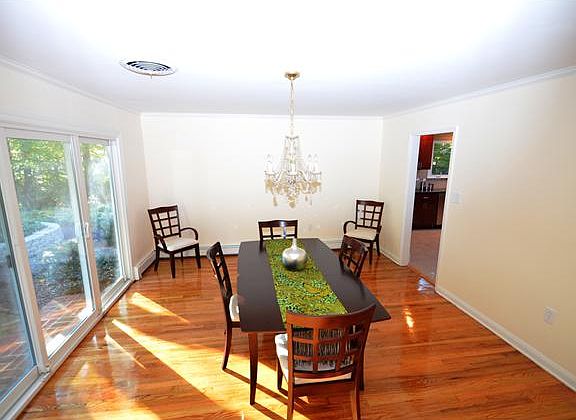 Dining room has a triple sliding glass door