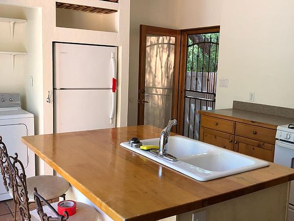kitchen comes with the stools. Enjoy the view out to the patio through the French doors.