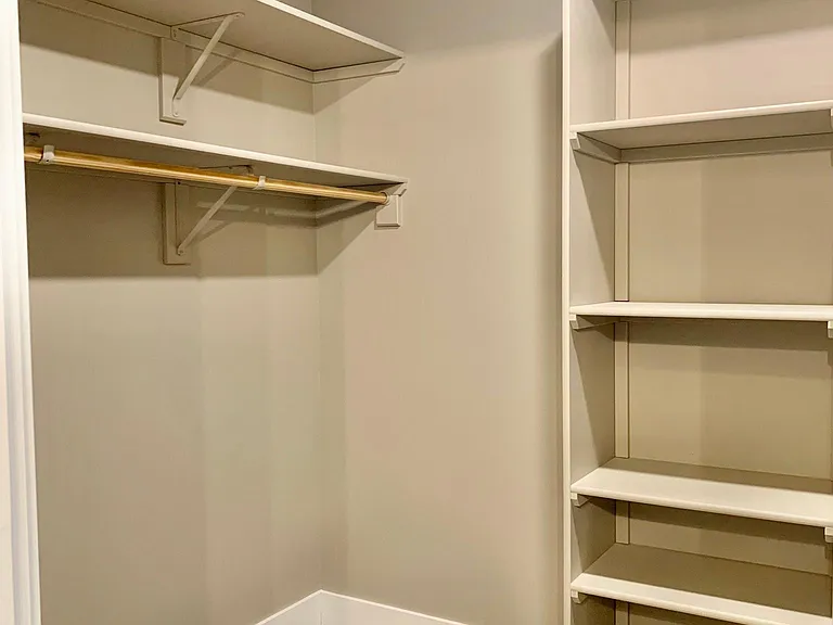 Lots of built-in storage in master closet