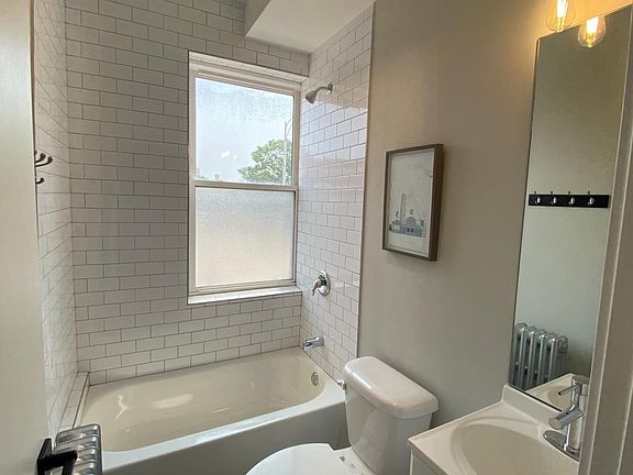 Modern bathroom with vintage bulbs and subway tiling