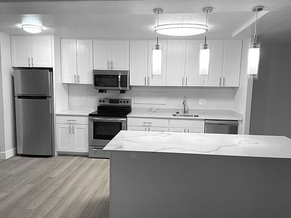 Modern White Kitchen With A Quartz Countertop