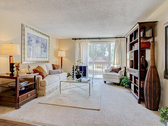 Staged living room with a sliding glass door leading to balcony.