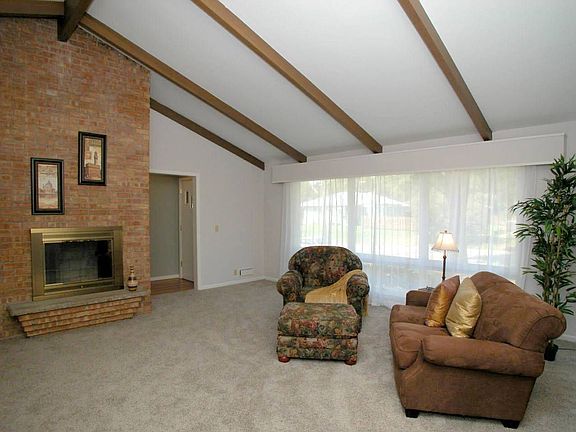 Large living room with vaulted ceilings, wood burning fireplace 