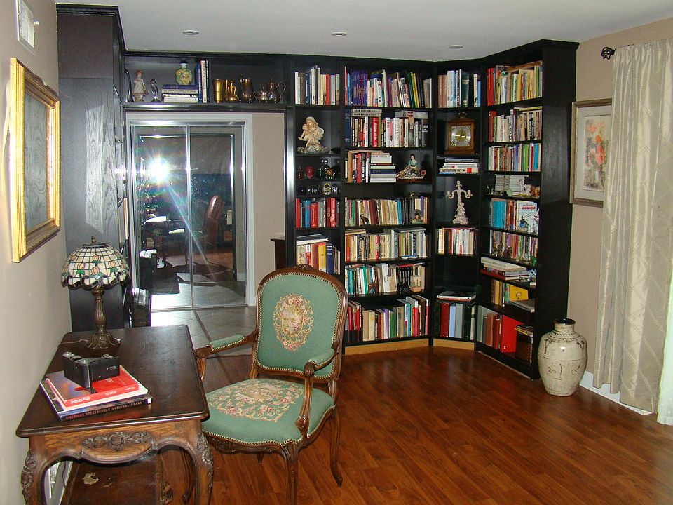 Front entry way leading into living room with custom inbuilt bookcase.