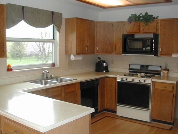 Kitchen with maple floors and light contemporary cabinets