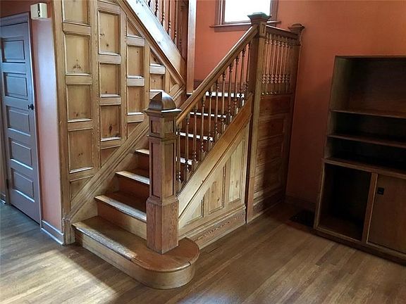 Entry with beautiful original stairwell woodwork and oak flooring.