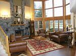 great room with soaring granite firepplace and wall of windows 