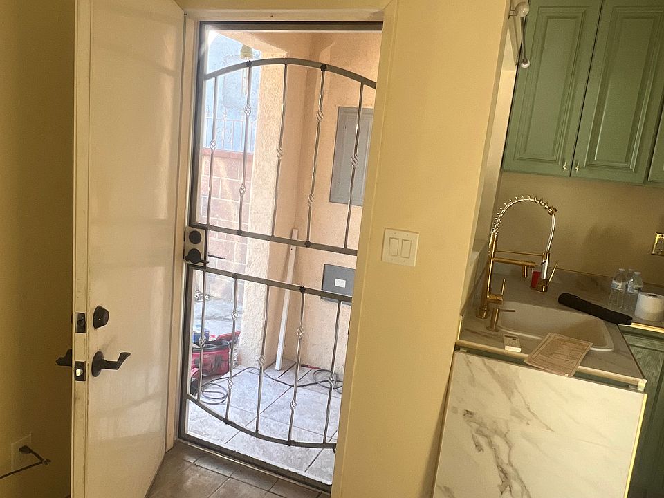 Private front entrance with secure screen door opens to a personal patio space_perfect for enjoying a morning coffee or unwinding outdoors.