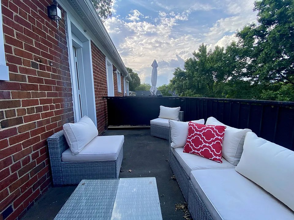 Northern facing balcony. You can't see the DC fireworks but you can see the sky light up. There's a very spacious common area before the next building. Several dogs run off leash there, some folks are planting more things.