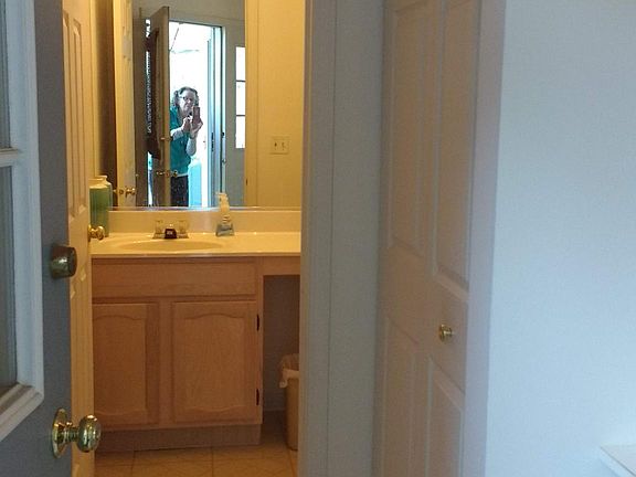 View from front door of the half bath. Large food pantry/storage on the right and door to garage on left. Coat closet to right of the door.