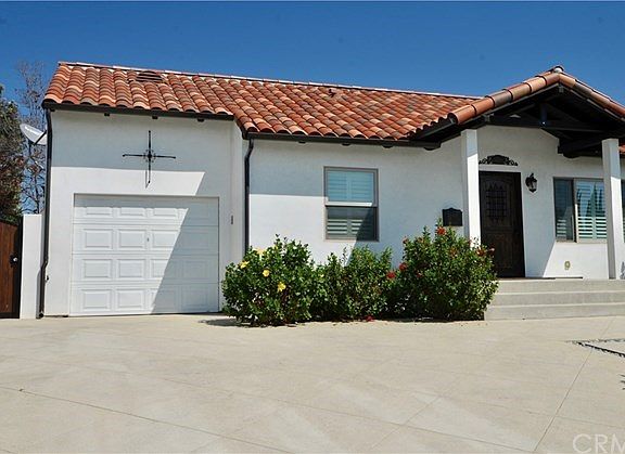 PERMITTED EXPANDED PARKING PAD AND ALL NEW CONCRETE DRIVEWAY LEAD TO THE FINISHED GARAGE.