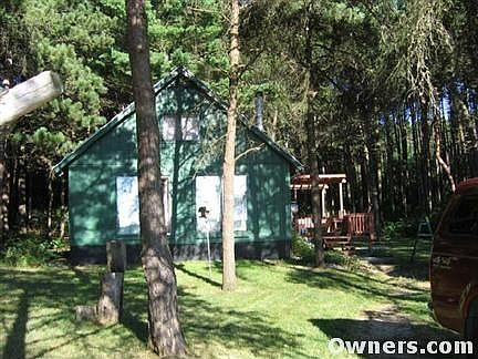 Well built home is nestled in the woods.