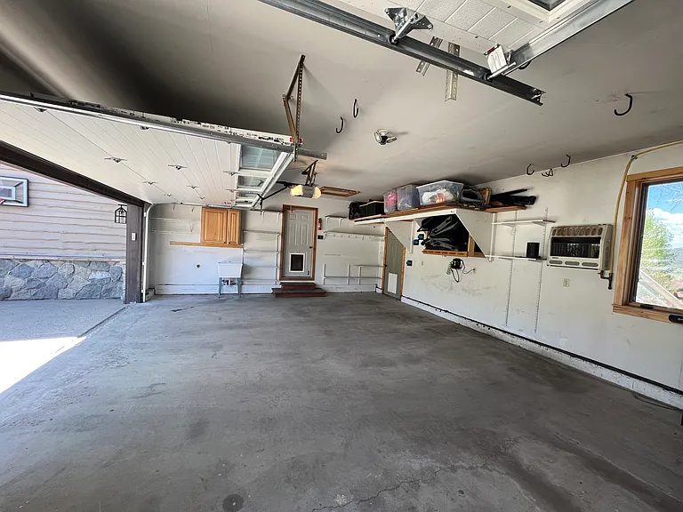 Expansive garage with sink and storage.