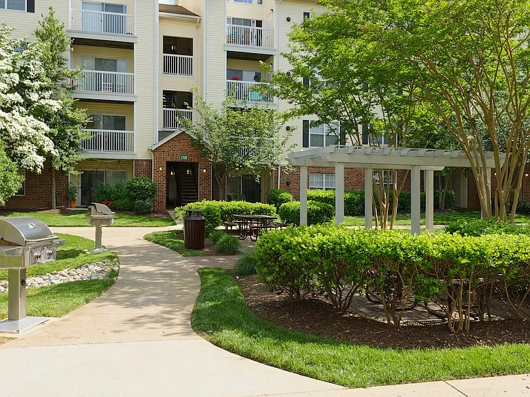 Landscaped courtyard with barbecue grills and seating