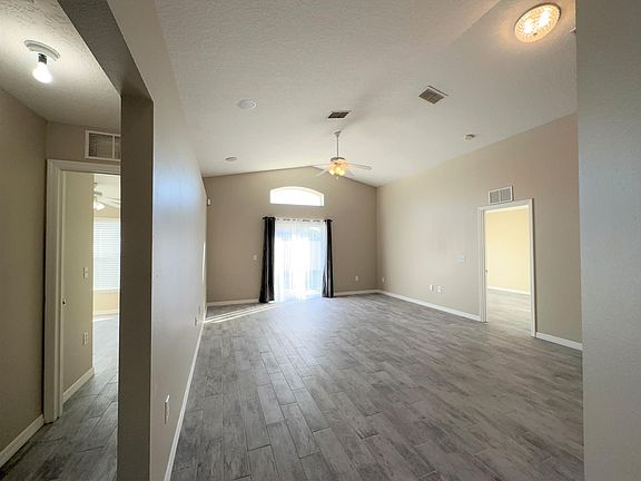 Beautiful Living Room with Porcelain Tile, Vaulted Ceilings, Surround Sound Wiring.