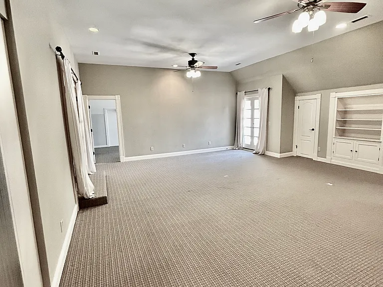 Recreation/media room with patio overlooking pool