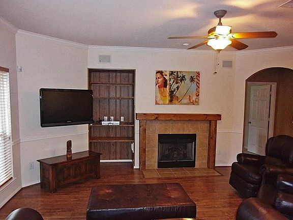The Heart Of The Home * Custom Fireplace Mantle * Entertainment Alcove * A Wall Of Windows Overlooks The Backyard Oasis