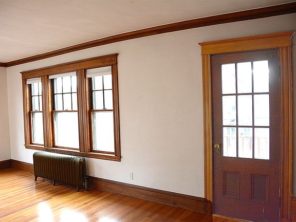 Look into the Living Room (A wall facing the street) from stairway landing. The door opens to the front deck.
