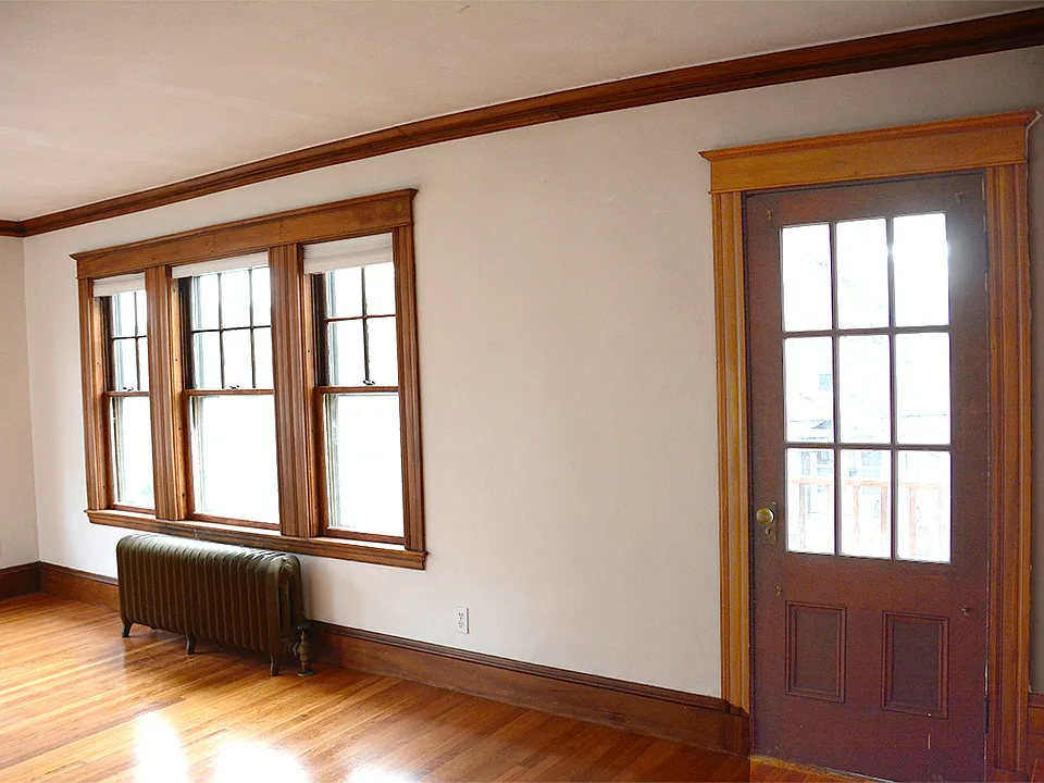 Look into the Living Room (A wall facing the street) from stairway landing. The door opens to the front deck.