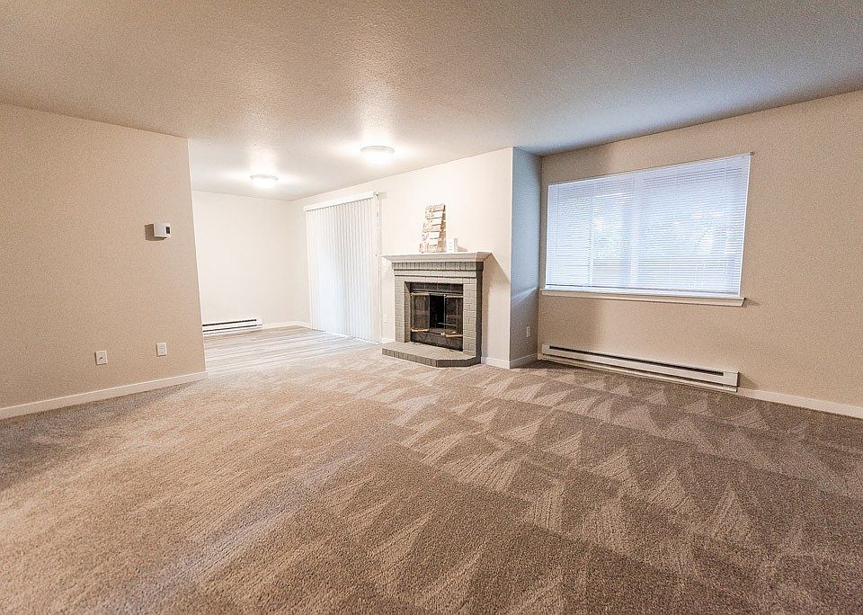 Puyallup Apartments - Cambridge on Seventh Apartments - Living Room, Fireplace, and Dining Room