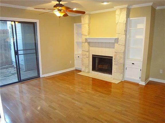 Living room with view of private fenced patio.
