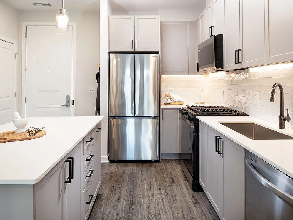 Modern with grey cabinetry, white quartz countertops, white tile backsplash, and stainless-steel appliances - Avalon Princeton on Harrison