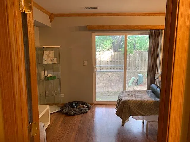 bedroom in walkout basement leading to backyard