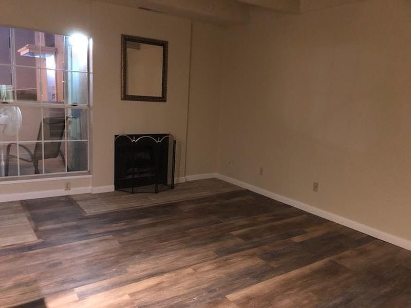 Living Room, Wood burning Fireplace, New Life-Pro Flooring Throughout except Entrance and Fireplace are tile.