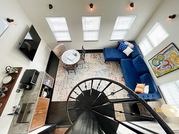 View of living area from lofted bedroom