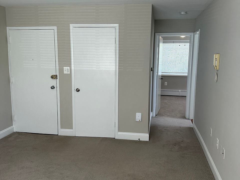 Living room area with closet and hallway to BA and BR