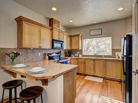 Kitchen with upgraded cabinets and lots of storage. Electric range, microwave, dishwasher and refrigerator.