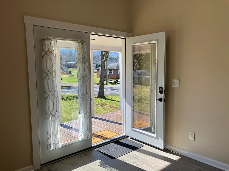 Double doors off of living room to small covered porch