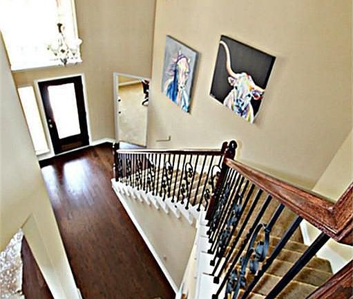 THIS WELCOMING FOYER IS COMPLETE WITH A LEAD GLASS FRONT DOOR, HARDWOOD FLOORS AND UPGRADED WROUGHT IRON SPINDLES ON THE STAIRCASE.