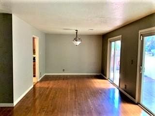 Dining Room (adjacent to Living Room). Sliding doors lead to covered patio and garden terrace. Door on back left leads to kitchen.