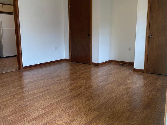 Living Room from front door. Laminate Flooring, Ceiling Fan, Freshly Painted, New Window Blind, 2 Closets.