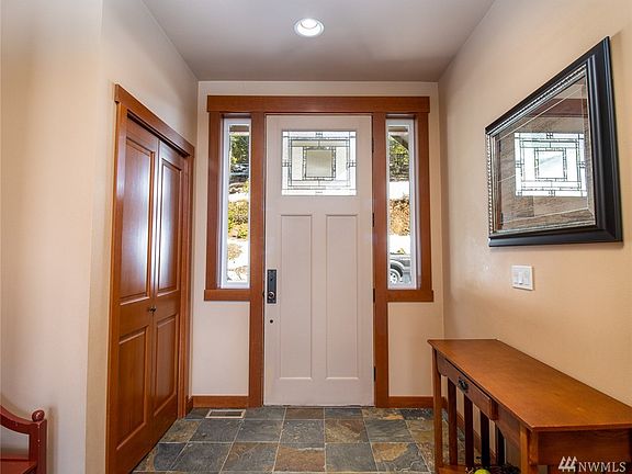Slate floor entry, etched glass door and custom millwork are showcased as soon as you enter the house.   