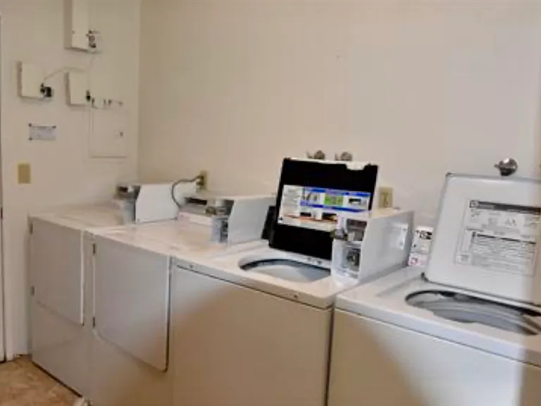 Laundry room in secured garage. Coin or App operated machines