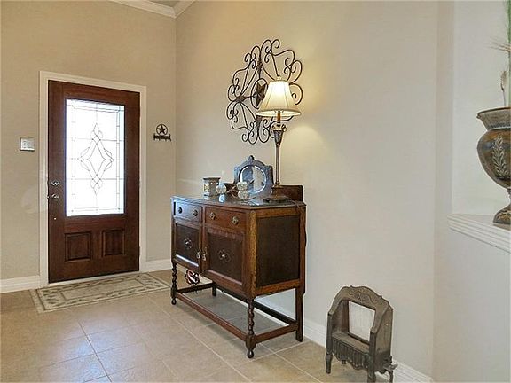 Wide foyer with high ceiling greets guests.