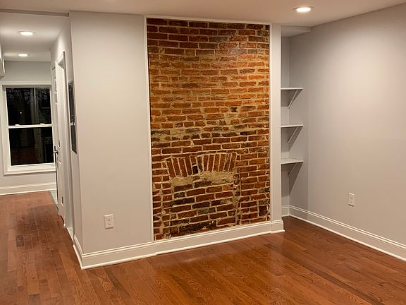 Living Room/Bedroom. Beautiful hardwood floors and exposed brick.