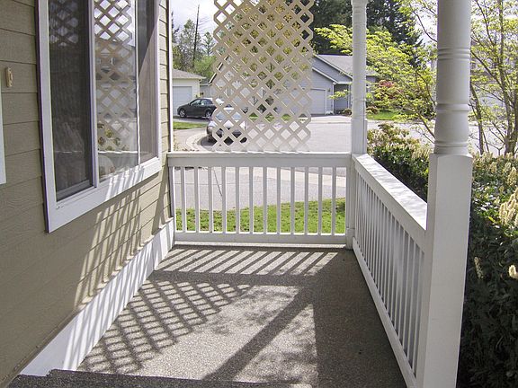 Covered country porch for sitting and great curb appeal