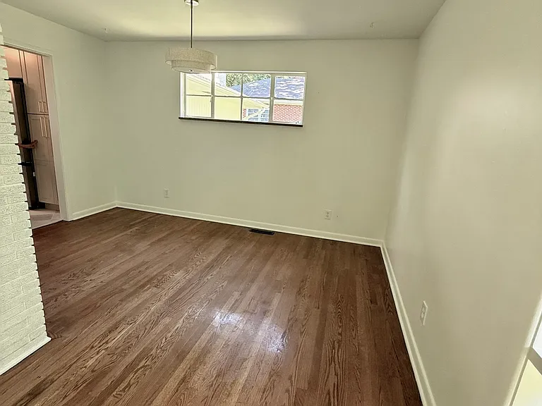 Dining room with newly refinished solid hardwood floors.