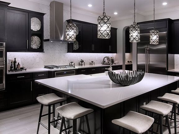 Chic quartz countertops make the kitchen a modern space with the functionality of a large center isl