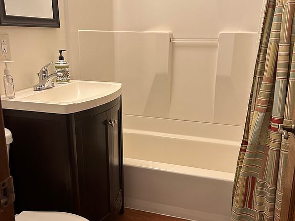 This is the shared full bathroom in the house on the first floor. It has a tub with a shower.