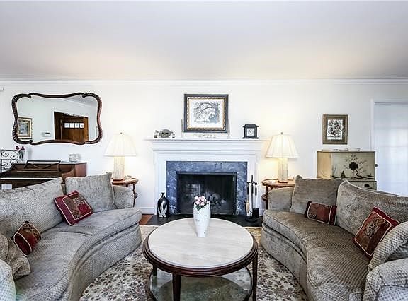 Sun filled living room with fireplace