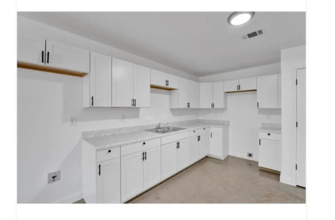 Renovated kitchen area featuring new cabinetry and a spacious layout - 2855 Choctaw Ave #2853