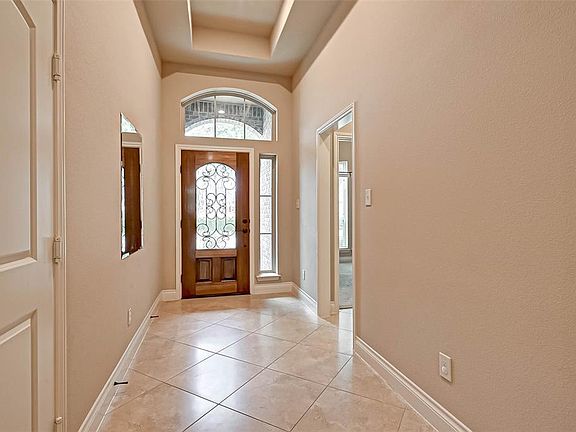 This house showcases its masterful design in the attention to detail. Notice the intricate design on the front door; a refreshing sight after a long day!